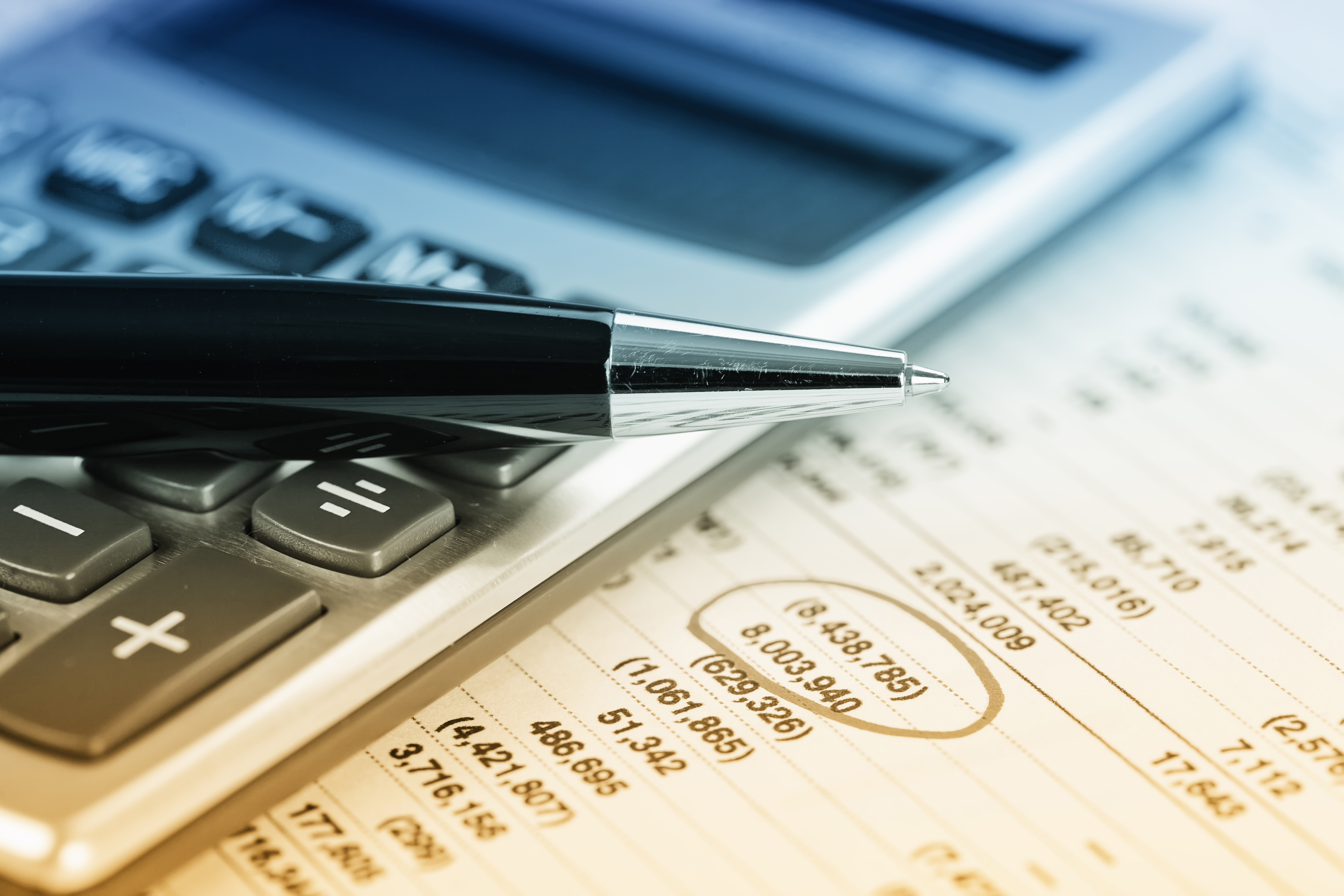 Image of pen, calculator, and budget sheet